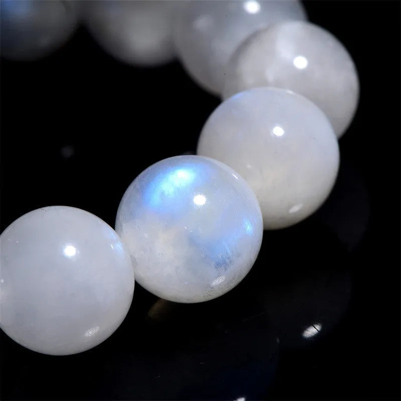 Natural blue moonlight round moonstone bead bracelet on wrist showing polished surface