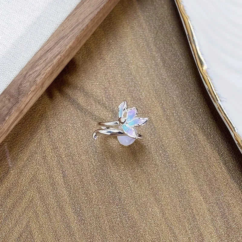 Close-up of an adjustable copper ring with an insect motif and an irregular dripping oil finish.