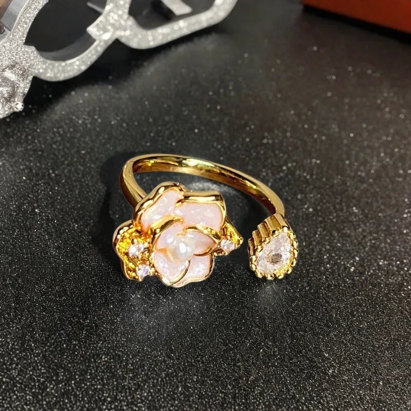 Copper adjustable ring with gourd, flower, and bow design featuring inlaid zircon stones in vintage finish.