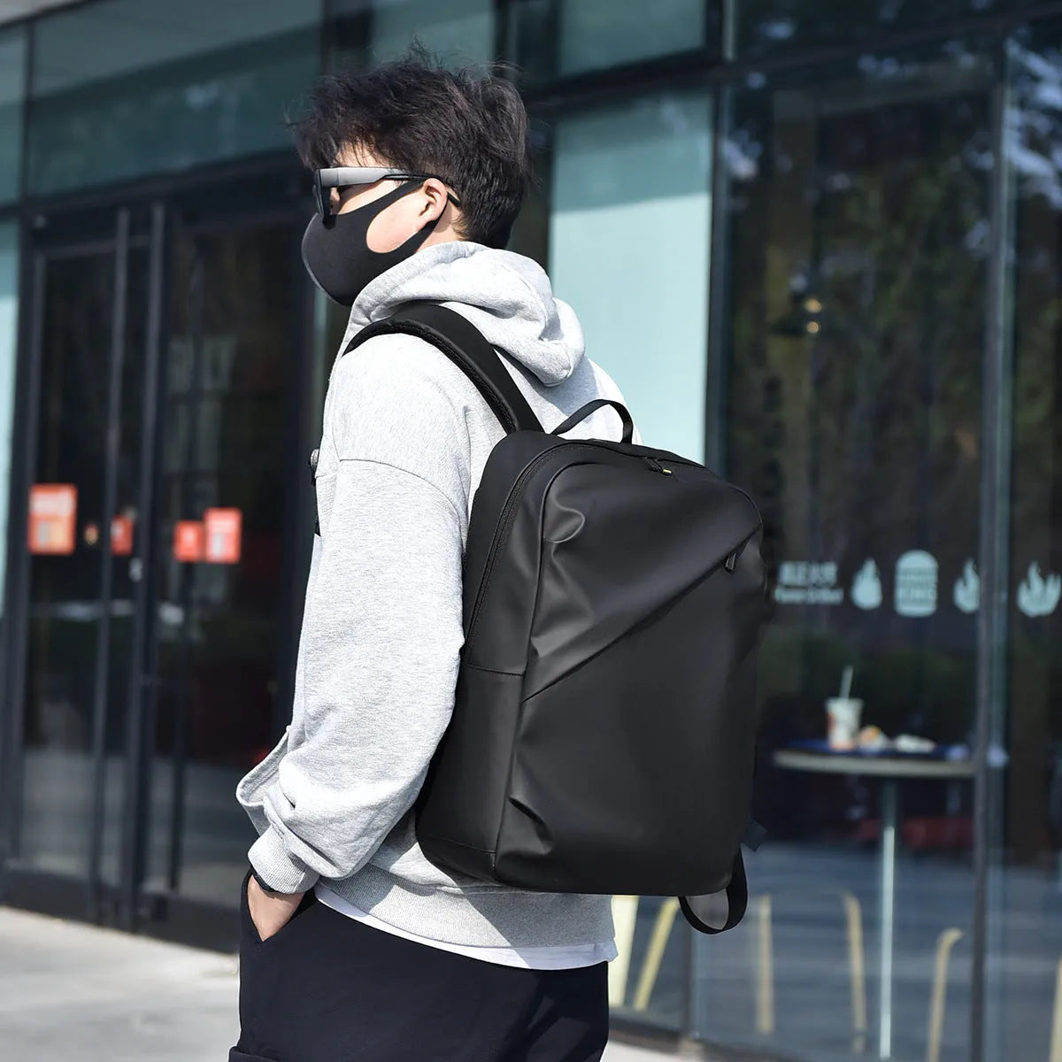 Men's large waterproof PU backpack in black, blue, or grey showing sewing thread details