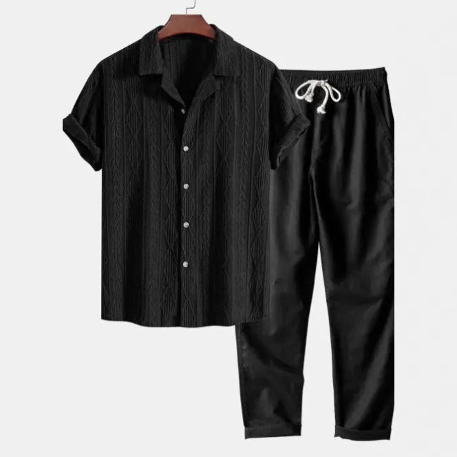 Men's camouflage print casual suit set with short-sleeve lapel shirt and trousers on a hanger.