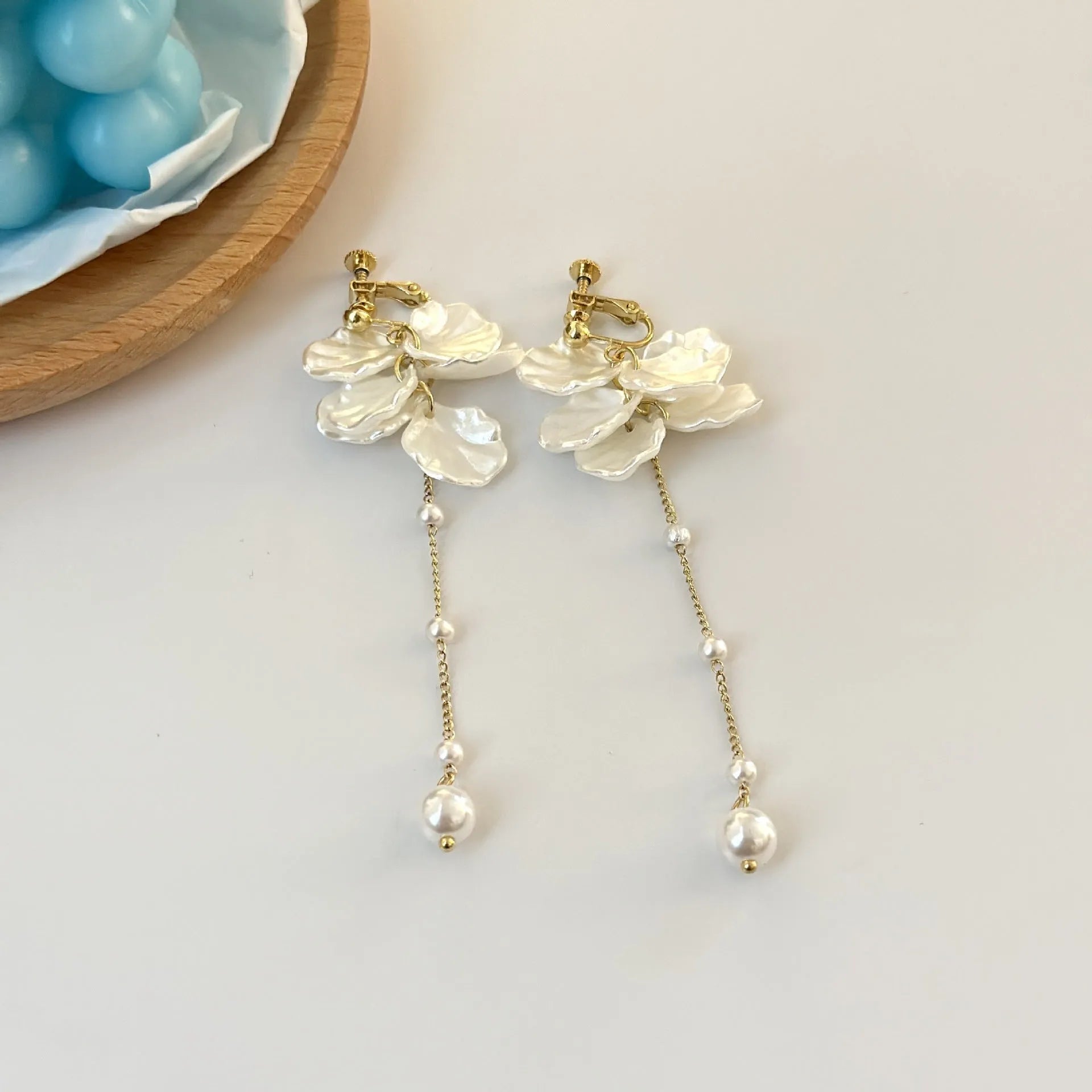 Long shell pearl tassel earrings with acrylic construction and multiple ear clip options