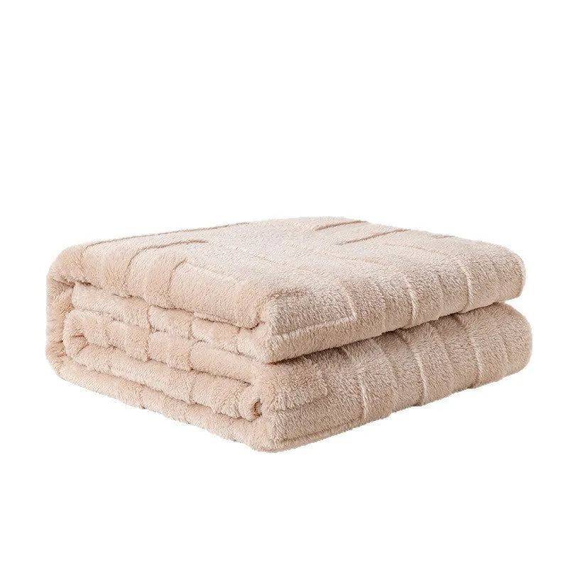 Thick coral fleece sofa blanket in a choice of colours and sizes draped over a grey sofa