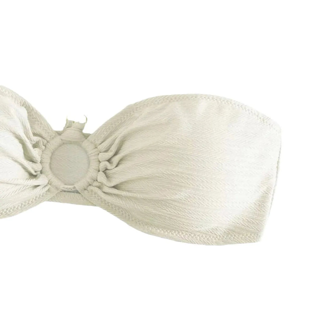 Women's creamy-white halter top and briefs bikini set for swimming on a beach