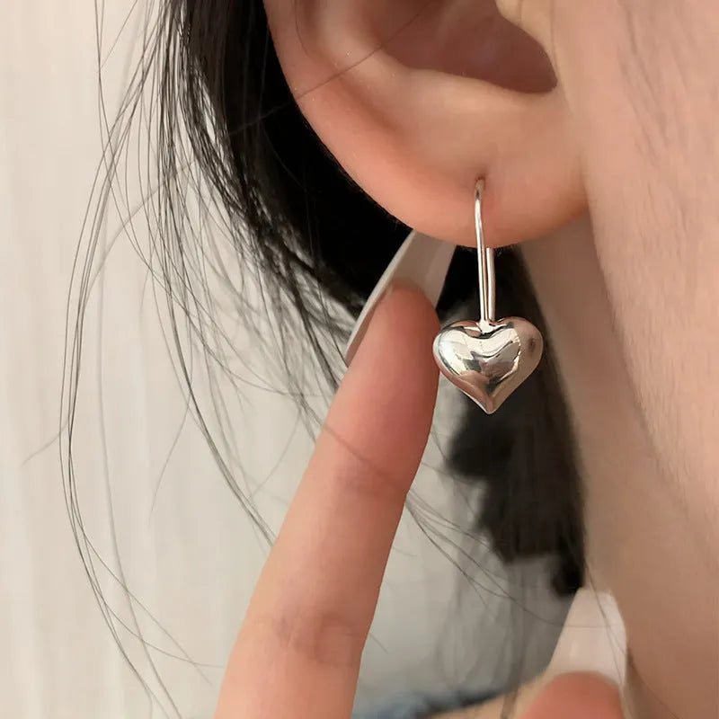 Silver Korean style heart earrings with three-dimensional glossy design and heart-shaped hooks