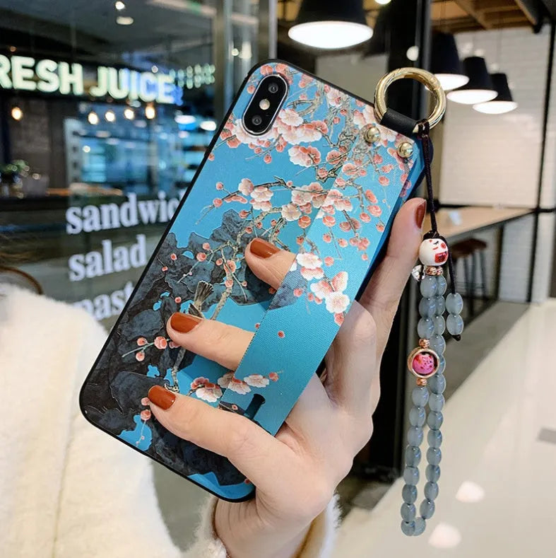 Rose floral patterned phone case with a wrist strap attachment point for iPhone.