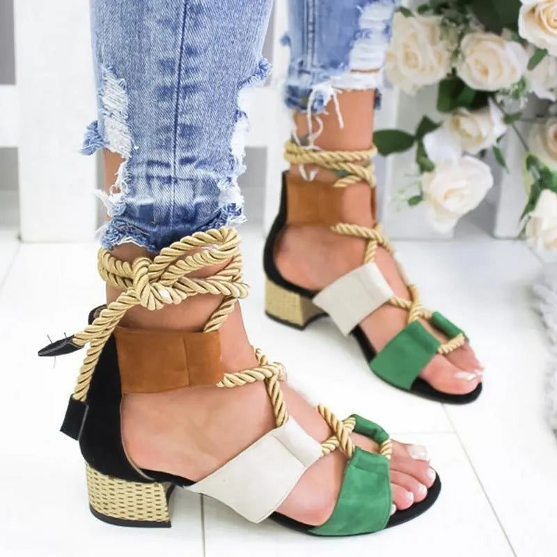 Women's beige suede sandals with thick mid-heel, front strap, and ankle strap on a plain background.