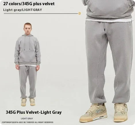 Man wearing dark brown velvet sweatpants with an ankle band and elastic waist.
