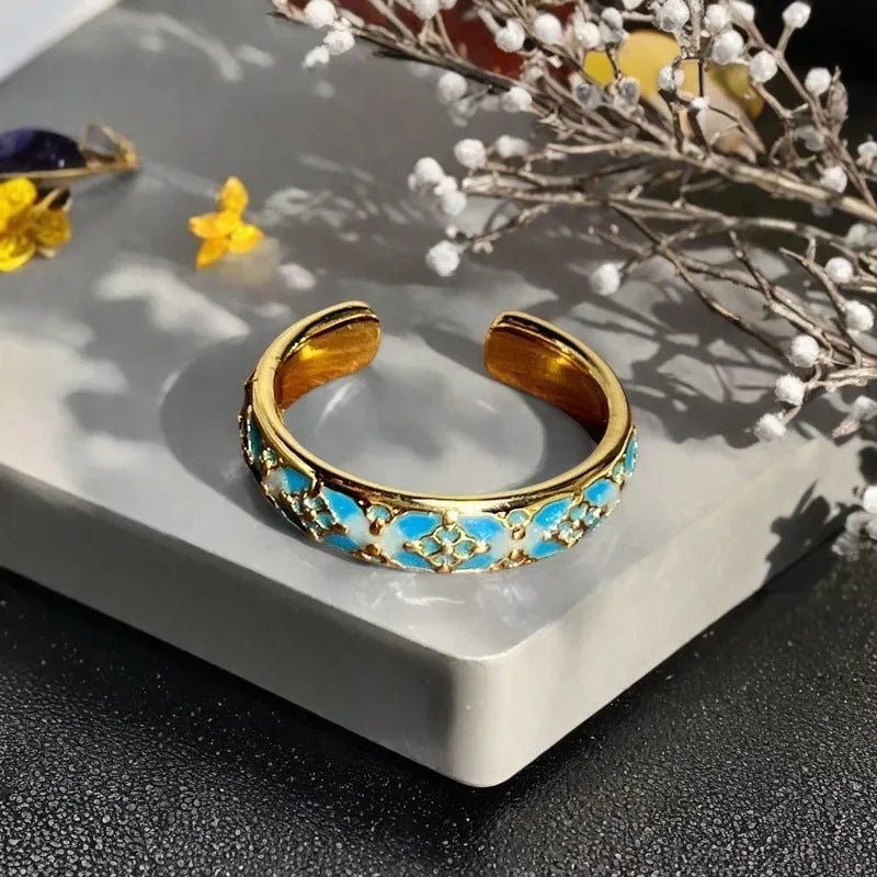 Copper adjustable ring with gourd, flower, and bow design featuring inlaid zircon stones in vintage finish.