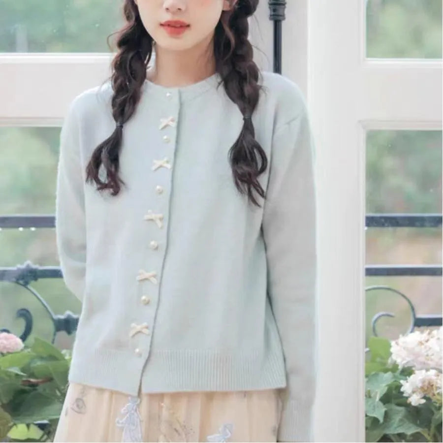 Women's acrylic cashmere cardigan sweater with bow and pearl button detail in nine colour options