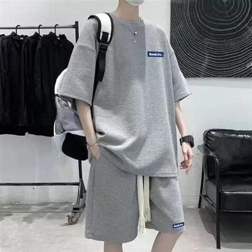 Waffle-textured cotton blend leisure sports suit set with short sleeve top and shorts.