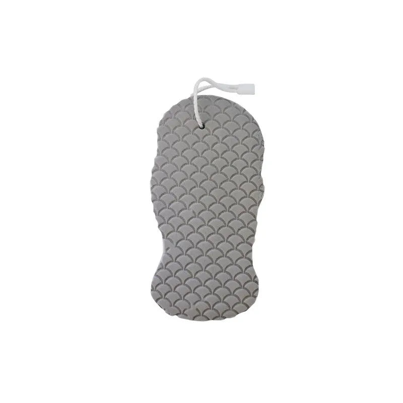 White 3D fish scale pattern bath sponge ball on a bathroom surface
