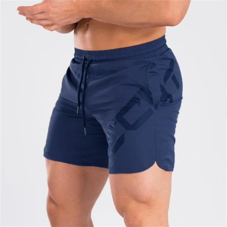 Man wearing black knee-length nylon running shorts during summer training.