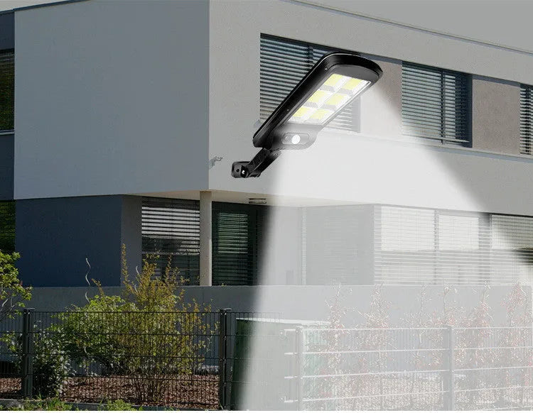 Black outdoor solar-powered motion sensor security light mounted on a wall.