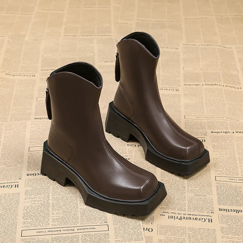 Black and brown platform Martin boots with square toe, high heel, and back zipper closure.