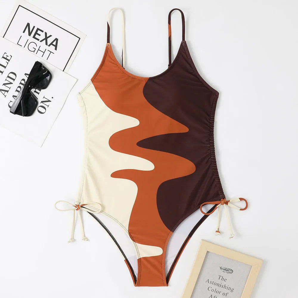 Women's sleeveless one-piece swimsuit in a striped print, showing backless design and available in multiple colours.