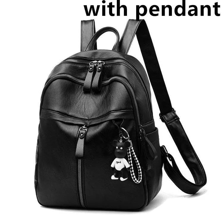 Black PU leather backpack with double shoulder straps showing luggage strap attachment