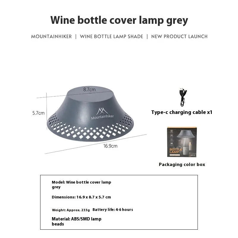Beige wine bottle shaped rechargeable camping lantern with LED light on a wooden surface.