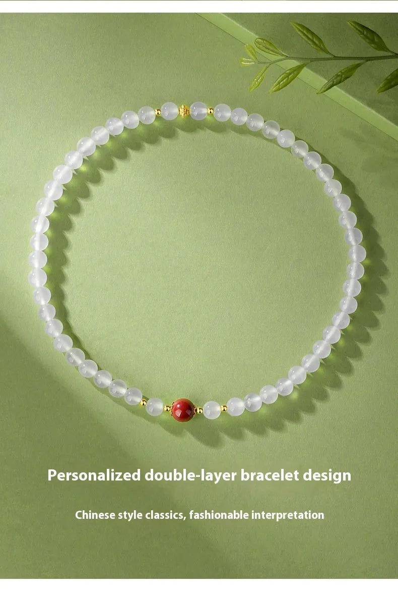White agate bracelet with jequirity bean and cinnabar beads, 6mm polished geometric shape