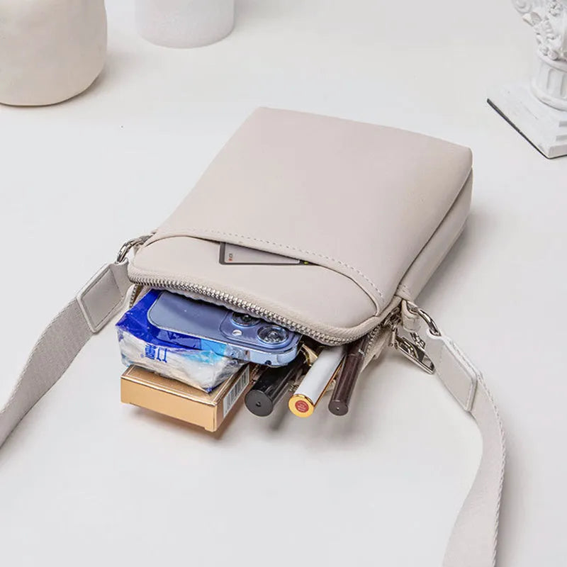 Solid colour PU leather crossbody phone bag for women shown in beige.
