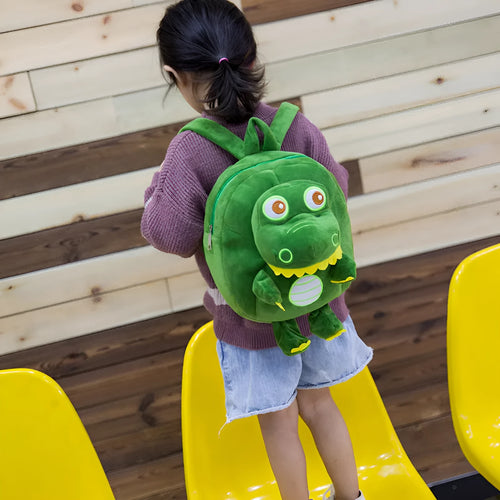 Soft blue dinosaur plush backpack with embroidered details and a soft handle.