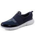 Women's blue, black, and grey lightweight mesh low-top sneakers on a hard floor.