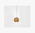 Nordic solid wood ball chandelier hanging lamp with adjustable cord over a dining table.
