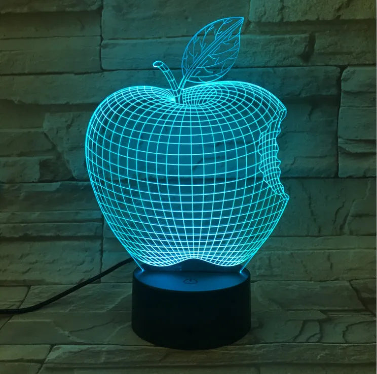 3D fruit-shaped night light with colourful LED glow on a tabletop.