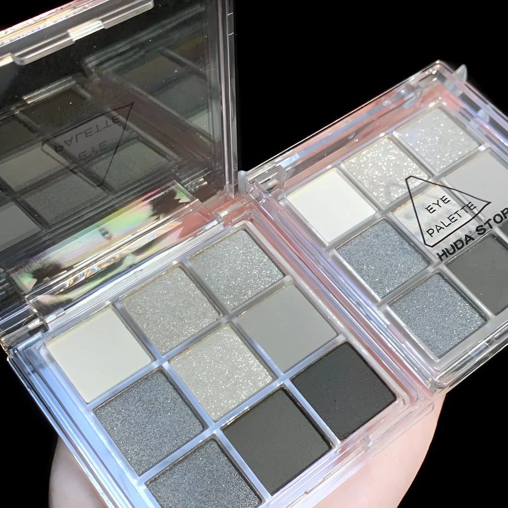 Smoked nine-colour eye shadow plate showing white, silver, black and iron grey pressed powder shades