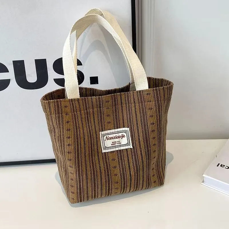 Japanese style corduroy handbag in dark brown showing textured fabric and minimalist design.