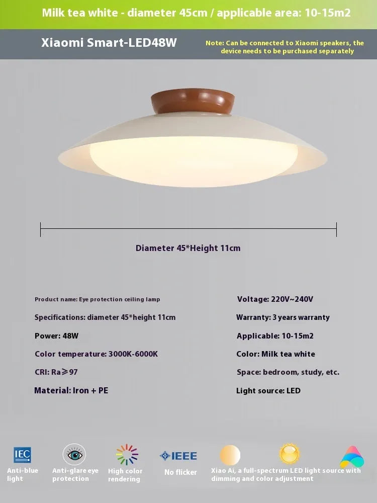 Modern cream-style flying saucer shaped ceiling lamp in a bedroom setting.