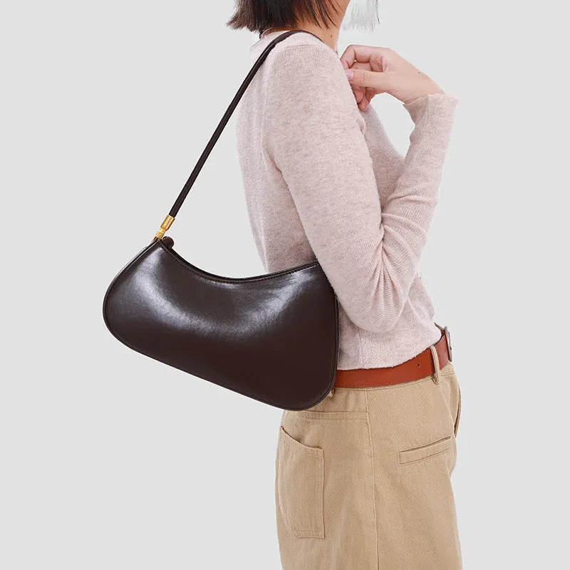 Women's oval shaped underarm bag in PU leather with single shoulder strap and internal zipper compartment