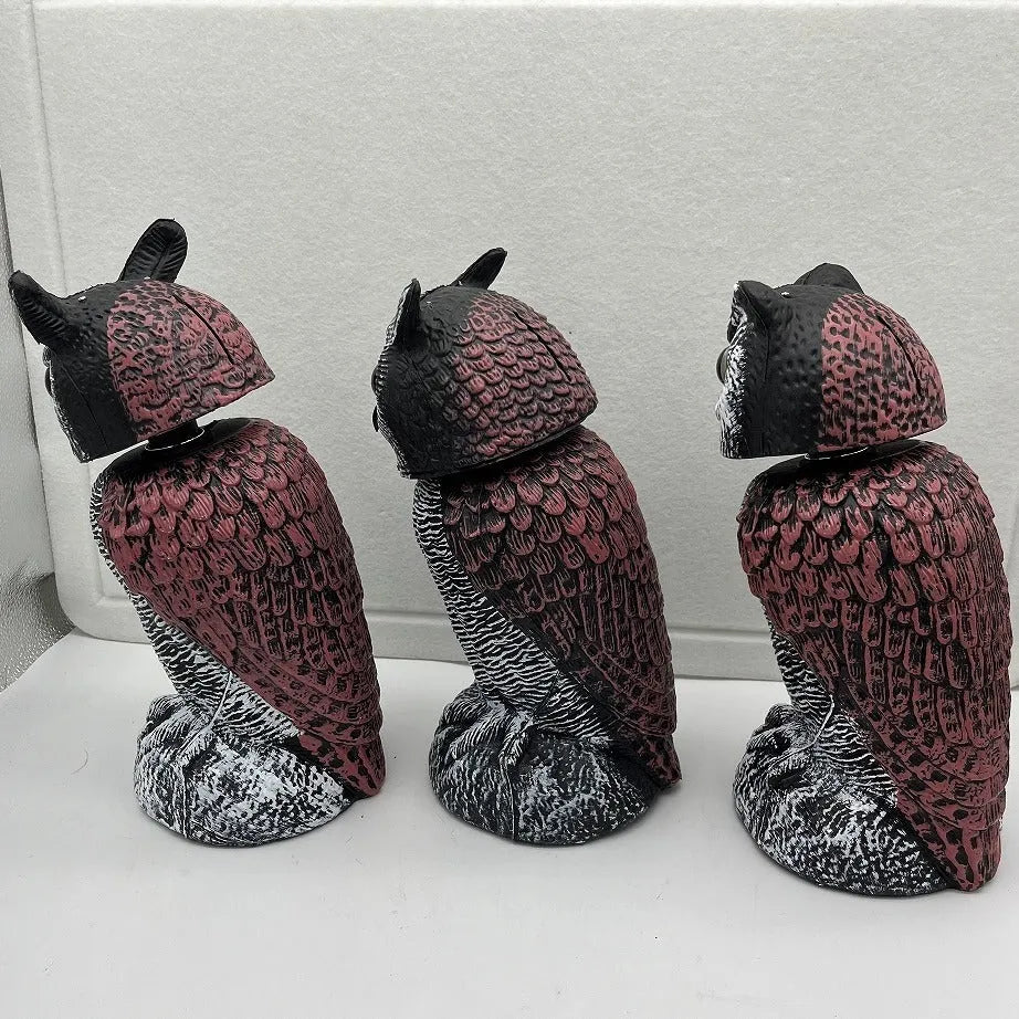 Artificial owl bait ornament with shaking head for garden bird deterrent in outdoor setting