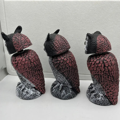 Artificial owl bait ornament with shaking head for garden bird deterrent in outdoor setting