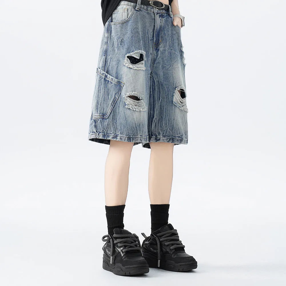 Washed denim shorts with ripped detailing in loose retro fit, black and blue colour options