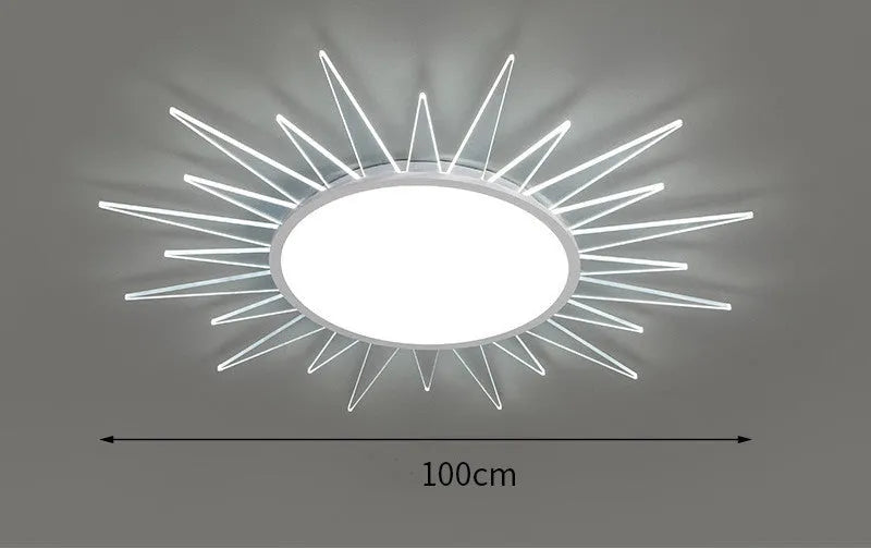 Modern round aluminium LED ceiling lamp with a white shade on a ceiling.