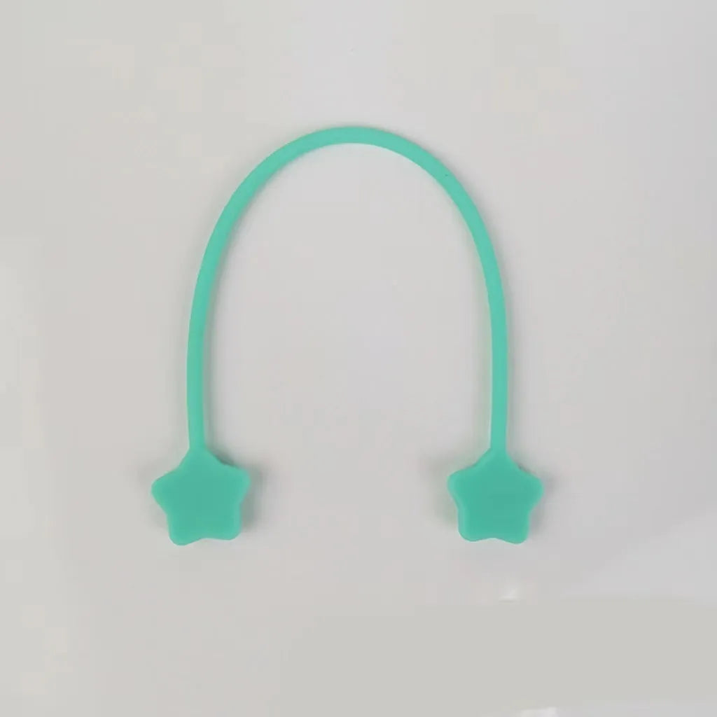 Purple silicone star-shaped magnet winder for clipping onto and organising headphone or phone charging cables.