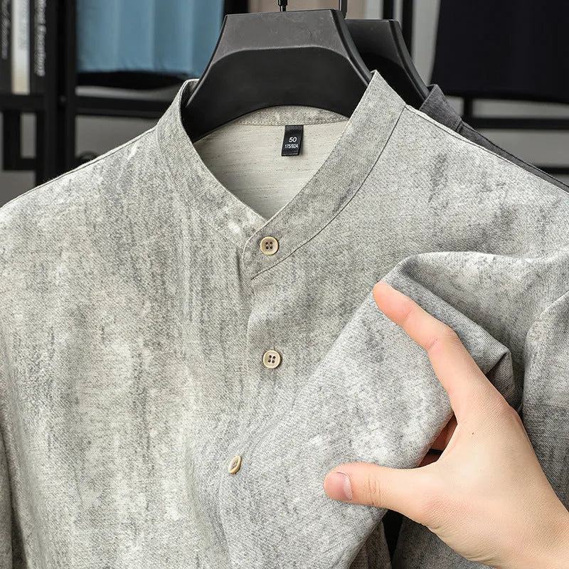 Men's loose grey linen cardigan shirt with a stand collar on a hanger.