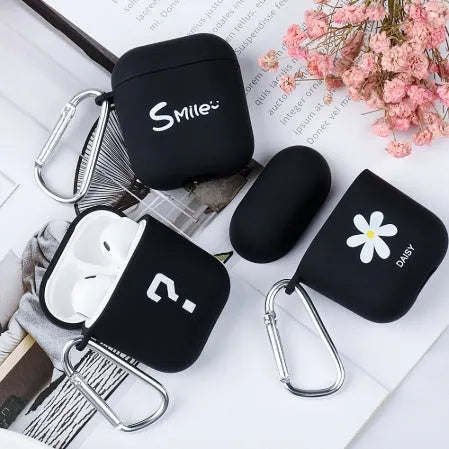 Black and pink AirPods case covers with floral and smiley face decorative patterns