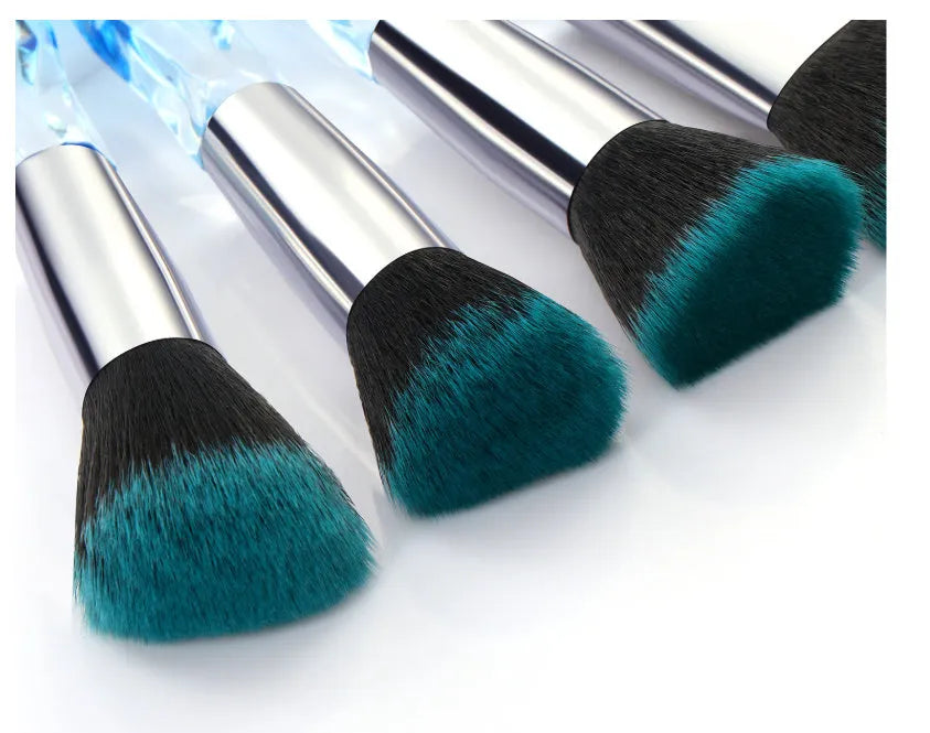 Set of 10 crystal-handled foundation brushes with synthetic bristles laid out flat.