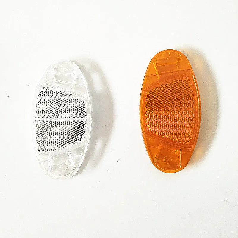 White and yellow plastic bicycle spoke reflector measuring 7.2cm by 3.5cm for night cycling safety