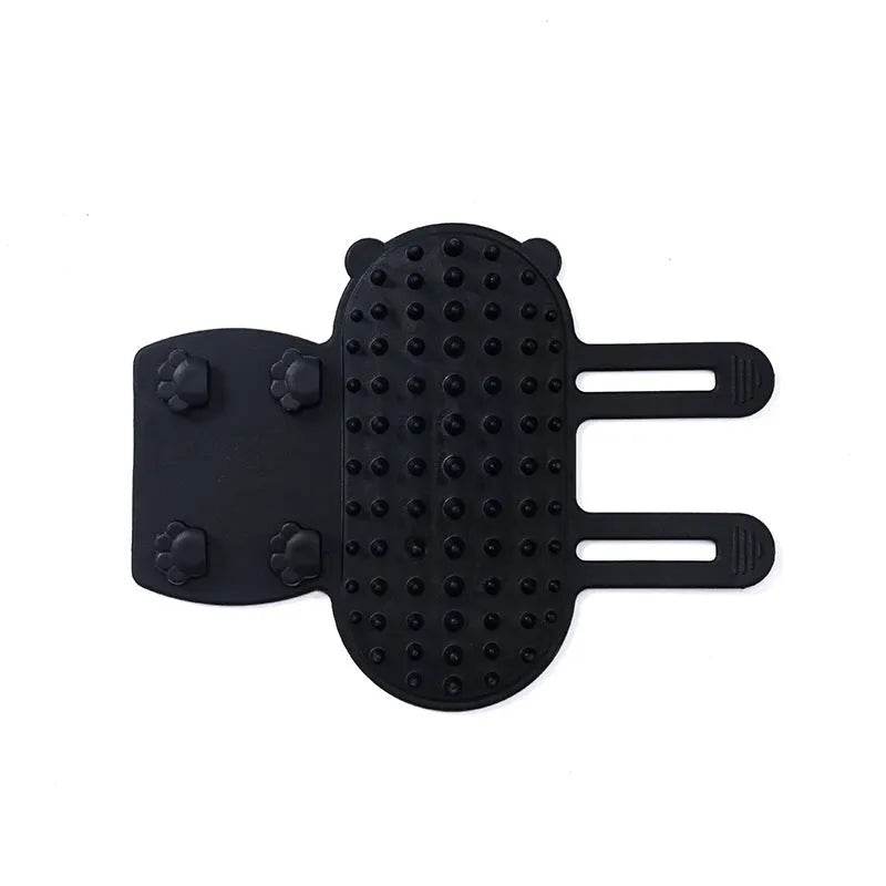 Silicone cat grooming comb with adjustable strap fastened to a table leg for self-cleaning