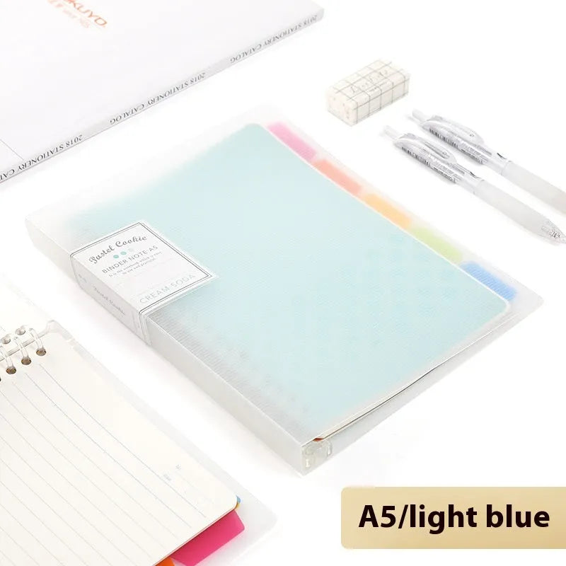 Refillable loose-leaf spiral notebook with PP cover open, showing raw wood pulp paper in grid ruling.