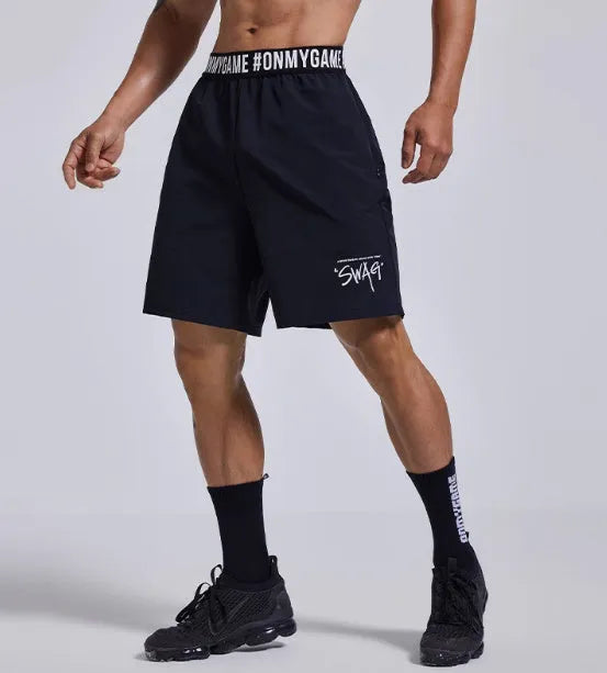 Men's loose grey athletic shorts with an elastic fly opening and letter print, shown from the front.