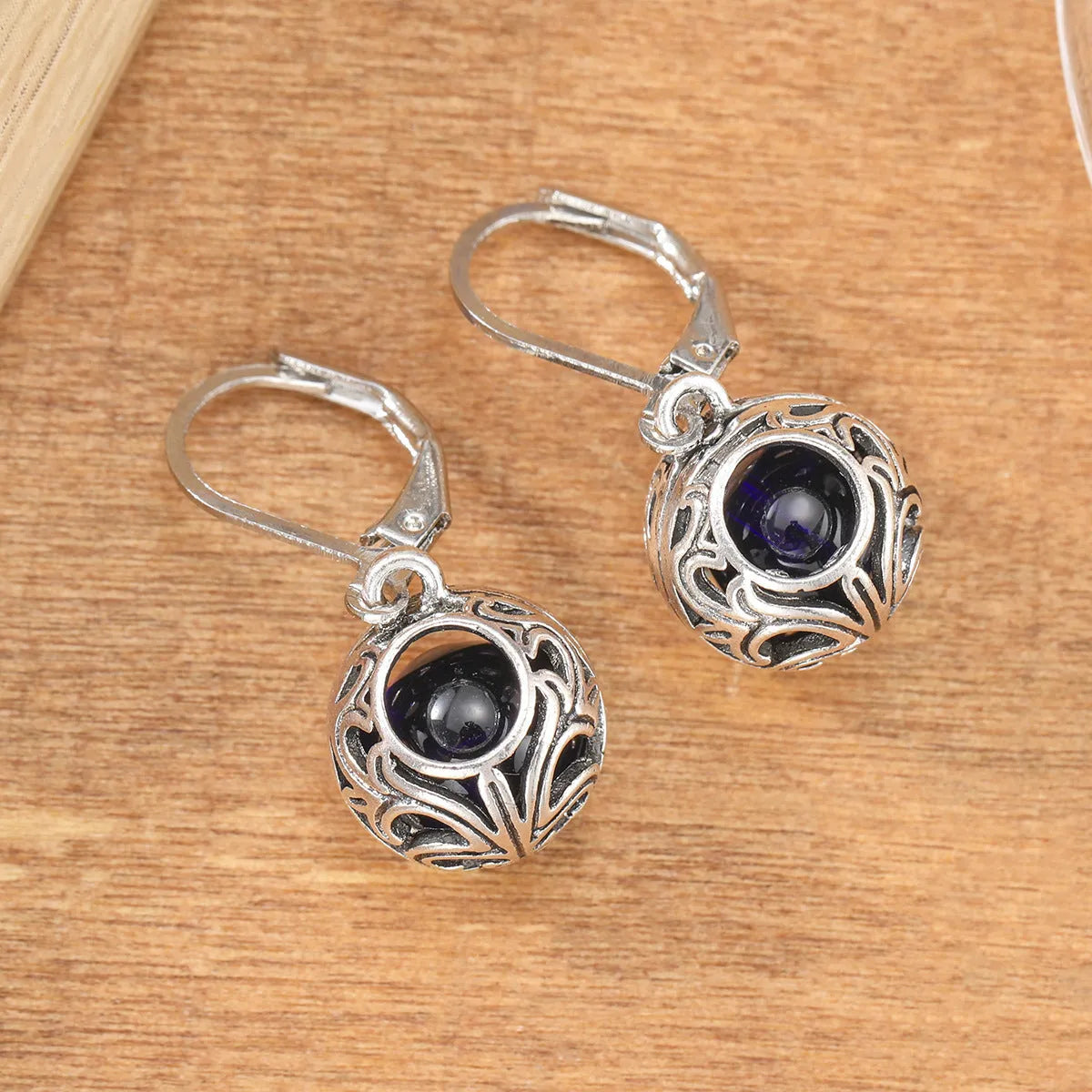 Vintage geometric blue gemstone pendant earrings with hollow engraving detail in silver-tone zinc alloy