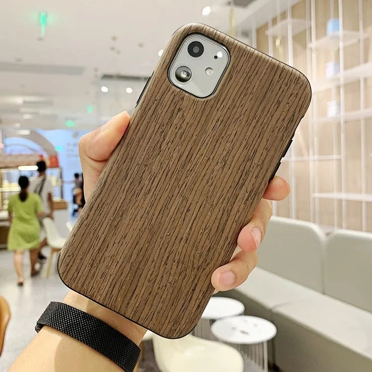 Natural wood grain iPhone back cover case in rosewood finish next to an iPhone