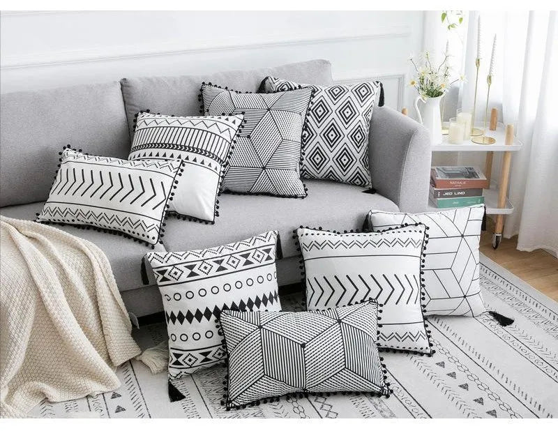 Bohemian patterned pillow cover in light gray on a living room sofa with decorative throw