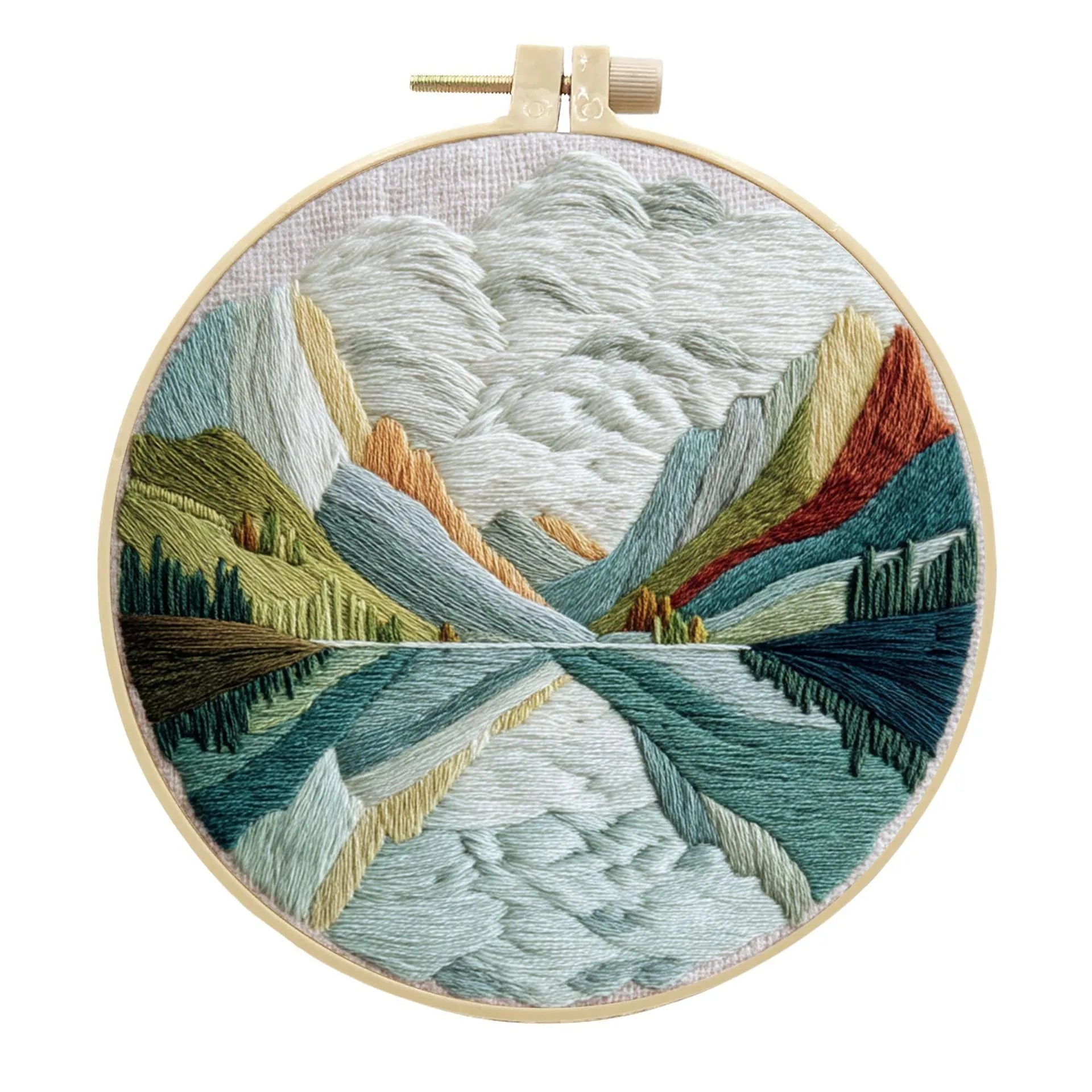 DIY embroidery kit with landscape-printed cotton fabric, embroidery hoop, needles, and coloured thread spools.