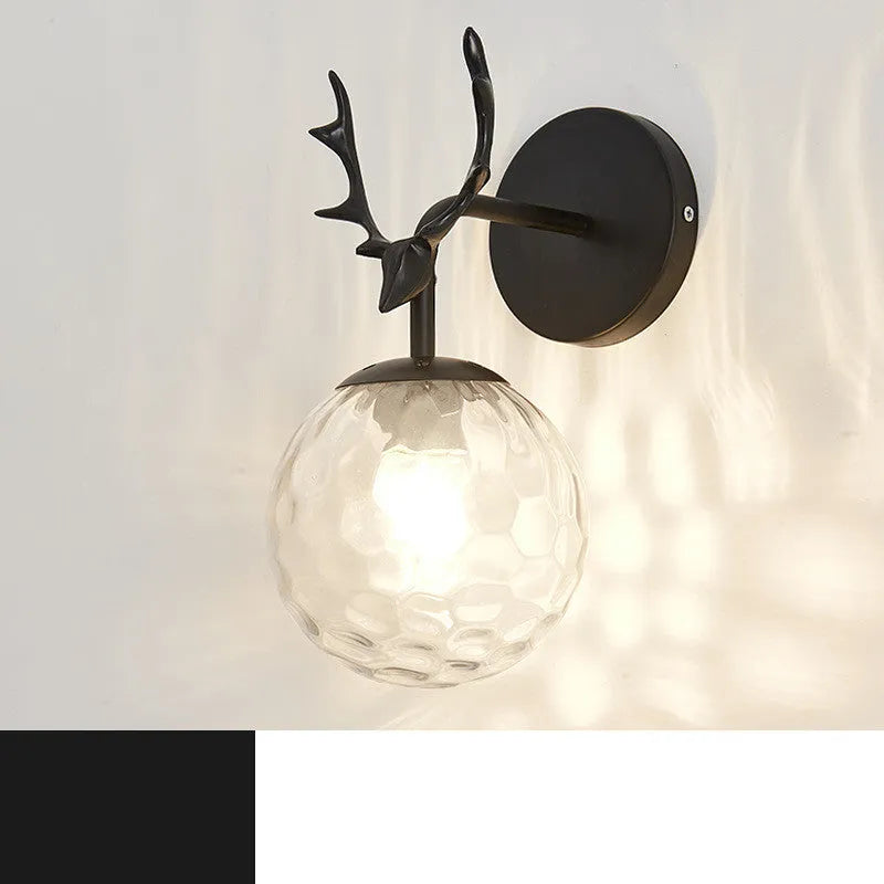 Nordic minimalist round glass wall lamp in golden finish mounted on a wall.