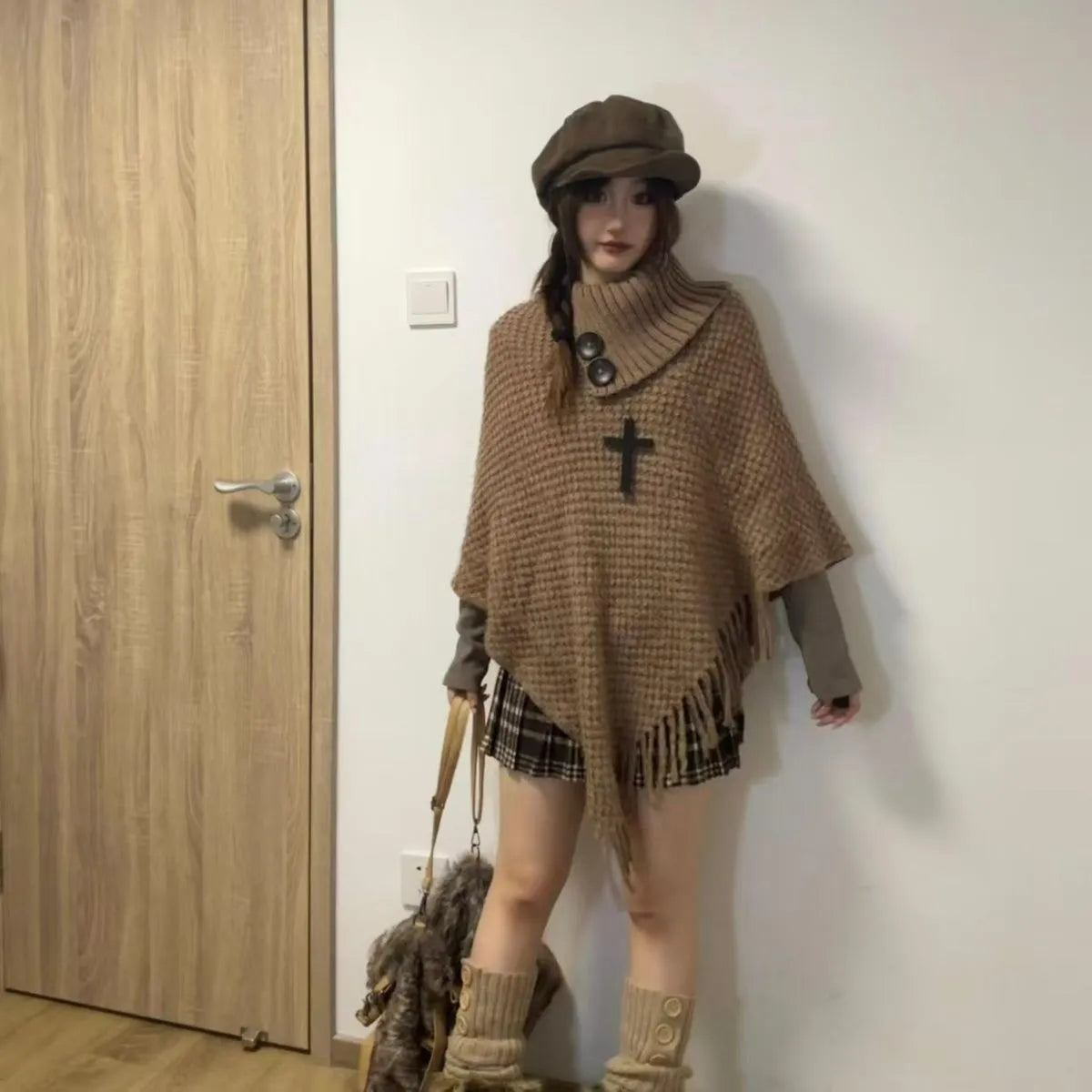 Women's plush cashmere blend triangle shawl cape with tassel trim in multiple colour options.